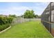 This backyard features a well-maintained lawn, privacy fencing, and easy access to the pool area at 1632 Ridge Top Way, Clearwater, FL 33765