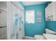 Bathroom with turtle-themed shower curtain and bright blue walls at 1632 Ridge Top Way, Clearwater, FL 33765
