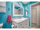 Bright bathroom with blue walls, anchor decor, and vanity at 1632 Ridge Top Way, Clearwater, FL 33765