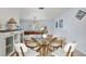 Bright dining area shows a glass table, white chairs, and a view into the game room at 1632 Ridge Top Way, Clearwater, FL 33765