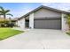 Charming home featuring a large garage, brick accents, and a well maintained lawn at 1632 Ridge Top Way, Clearwater, FL 33765