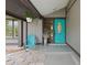 Inviting front porch with a decorative front door, chair, and overhead plants at 1632 Ridge Top Way, Clearwater, FL 33765