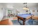 A billiards room seamlessly combines recreation with dining; natural light and stylish decor make for elegant entertaining at 1632 Ridge Top Way, Clearwater, FL 33765