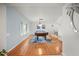 An open and airy recreation space featuring a wooden pool table, hardwood floors and bright, neutral walls and trim at 1632 Ridge Top Way, Clearwater, FL 33765