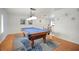 Game room features a pool table with blue felt, stylish rug, and modern lighting at 1632 Ridge Top Way, Clearwater, FL 33765