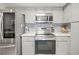A modern kitchen showcasing stainless steel appliances, sleek countertops, and backsplash for a stylish and functional cooking space at 1632 Ridge Top Way, Clearwater, FL 33765