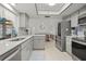 Modern kitchen with stainless steel appliances, ample counter space, and tile backsplash at 1632 Ridge Top Way, Clearwater, FL 33765
