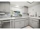 Well-lit kitchen featuring white countertops, tiled backsplash, and stainless steel appliances at 1632 Ridge Top Way, Clearwater, FL 33765