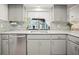 Bright kitchen with stainless steel appliances, light countertops, and backsplash at 1632 Ridge Top Way, Clearwater, FL 33765