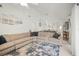 Open living room with neutral sectional sofa, fan, and modern decor at 1632 Ridge Top Way, Clearwater, FL 33765