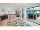 Bright living room open to kitchen and lanai with a large comfy sectional at 1632 Ridge Top Way, Clearwater, FL 33765