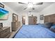 Spacious bedroom with large bed, wooden furniture, ceiling fan, and walk-in closet at 1632 Ridge Top Way, Clearwater, FL 33765