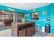 This covered patio features fun decor, a table with seating, and access to the pool area at 1632 Ridge Top Way, Clearwater, FL 33765