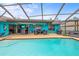 An outdoor entertaining space features a screened-in pool and covered patio at 1632 Ridge Top Way, Clearwater, FL 33765