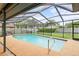 This fenced in pool features a cool, blue water and a spacious concrete patio at 1632 Ridge Top Way, Clearwater, FL 33765