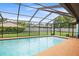 This fenced in pool features a cool, blue water and a spacious concrete patio at 1632 Ridge Top Way, Clearwater, FL 33765