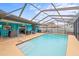 Enjoy the screened-in swimming pool with a covered patio area with fun decor for relaxing and entertaining at 1632 Ridge Top Way, Clearwater, FL 33765