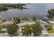 Stunning aerial view of waterfront property with mature trees and lake access at 17 Freshwater Dr, Palm Harbor, FL 34684