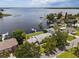 Breathtaking aerial view of a waterfront home with a private dock and access to a tranquil lake at 17 Freshwater Dr, Palm Harbor, FL 34684