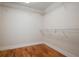 A walk-in closet featuring custom shelving and hardwood floors at 17 Freshwater Dr, Palm Harbor, FL 34684