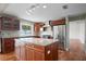 Elegant kitchen with stainless steel appliances, granite countertops, and wood cabinetry at 17 Freshwater Dr, Palm Harbor, FL 34684