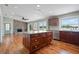 Open-concept living space with a stylish kitchen island and a stone fireplace at 17 Freshwater Dr, Palm Harbor, FL 34684