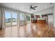 Spacious living area with hardwood floors, and sliding glass doors leading to the backyard and lake at 17 Freshwater Dr, Palm Harbor, FL 34684