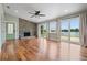 Spacious living room with a stone fireplace, hardwood floors, and sliding glass doors to the waterfront at 17 Freshwater Dr, Palm Harbor, FL 34684