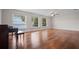 Bright living room featuring hardwood floors, three windows with waterfront views, and a ceiling fan at 17 Freshwater Dr, Palm Harbor, FL 34684