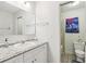 Clean bathroom with a single sink vanity, white cabinets, granite countertop, and a toilet in an adjacent room at 1732 Flamingo Ln, Sun City Center, FL 33573