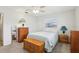 Bedroom features neutral carpet, ceiling fan, two windows, and traditional wooden furniture at 1732 Flamingo Ln, Sun City Center, FL 33573
