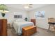 Cozy bedroom with carpet, a ceiling fan, two windows, and traditional furniture at 1732 Flamingo Ln, Sun City Center, FL 33573