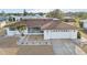Charming home featuring a well-maintained front yard, a screened porch, and an attached two-car garage at 1732 Flamingo Ln, Sun City Center, FL 33573