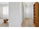 Bright hallway with hardwood floors, closet and shelving near the living room at 1732 Flamingo Ln, Sun City Center, FL 33573