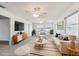 Bright living room with contemporary furniture, a large window, and neutral tones at 1732 Flamingo Ln, Sun City Center, FL 33573