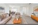 Staged living room featuring neutral furniture, stylish decor, and an open layout at 1732 Flamingo Ln, Sun City Center, FL 33573