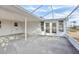 Covered patio with concrete flooring and screened enclosure, providing an outdoor living area at 1732 Flamingo Ln, Sun City Center, FL 33573