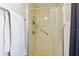 The tiled shower has a sliding glass door, safety bar, and a wall mounted shower head at 1732 Flamingo Ln, Sun City Center, FL 33573