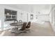 Enclosed sunroom with lots of light, neutral carpeting, a ceiling fan and a table with four chairs at 1732 Flamingo Ln, Sun City Center, FL 33573