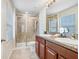 Bathroom featuring a double vanity, glass shower, and modern fixtures at 17378 Cruiser Bnd, Land O Lakes, FL 34638