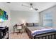 Comfortable bedroom with ceiling fan, desk, and good natural light from window at 17378 Cruiser Bnd, Land O Lakes, FL 34638
