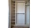 An open closet with shelves and closet rods offers storage space and organization at 17378 Cruiser Bnd, Land O Lakes, FL 34638
