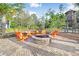 Cozy outdoor fire pit with comfortable Adirondack chairs, perfect for gathering with friends and Gathering at 17378 Cruiser Bnd, Land O Lakes, FL 34638