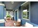 Relaxing front porch with brick floor and comfortable seating at 17378 Cruiser Bnd, Land O Lakes, FL 34638