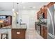 Well-appointed kitchen featuring a large island with granite counter and stainless steel appliances at 17378 Cruiser Bnd, Land O Lakes, FL 34638