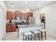 Modern kitchen with granite countertops, stainless steel appliances, and an island with seating at 17378 Cruiser Bnd, Land O Lakes, FL 34638