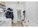 A well-organized laundry room with washer, dryer, shelving, and access to the exterior at 17378 Cruiser Bnd, Land O Lakes, FL 34638