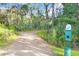 Pet waste station along a walking trail in a wooded area provides convenience for dog owners at 17378 Cruiser Bnd, Land O Lakes, FL 34638