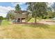 Community playground featuring a wooden structure, slides, and shade trees with a nearby seating area at 17378 Cruiser Bnd, Land O Lakes, FL 34638