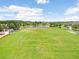 Expansive community soccer field with lush green grass and a view of a playground, pond, and pavilion at 17378 Cruiser Bnd, Land O Lakes, FL 34638